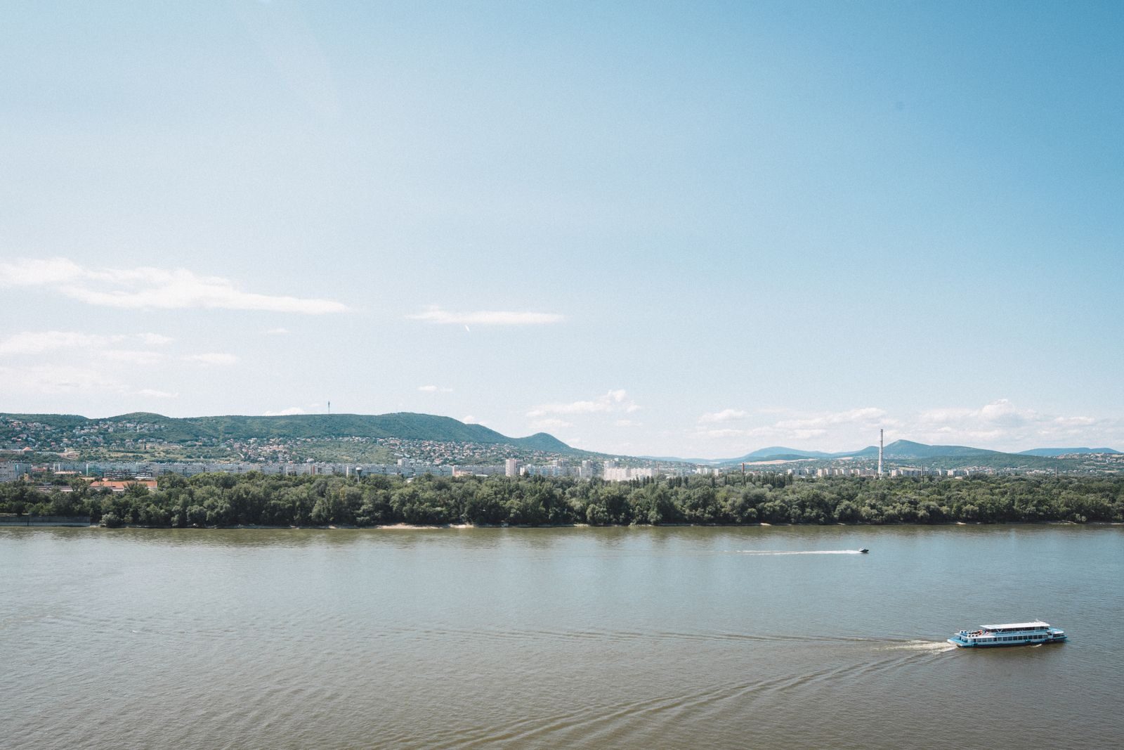 A serene view of the Danube River with a distant panorama of Budapest, Hungary.