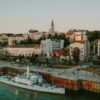 A harbor with boats and a city in the background