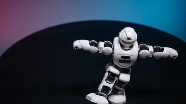 A futuristic white robot toy performing on a sleek dark surface.