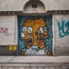 Street art of a popular cartoon character on a Viennese building door, showcasing urban creativity.