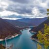 Aerial view of Lake Piva surrounded by mountains in Montenegro, showcasing natural beauty.