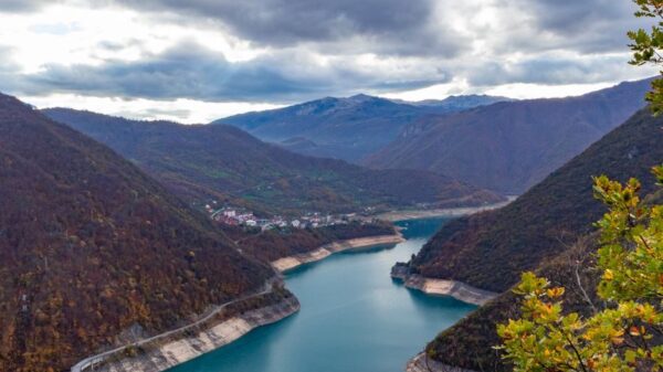 Aerial view of Lake Piva surrounded by mountains in Montenegro, showcasing natural beauty.