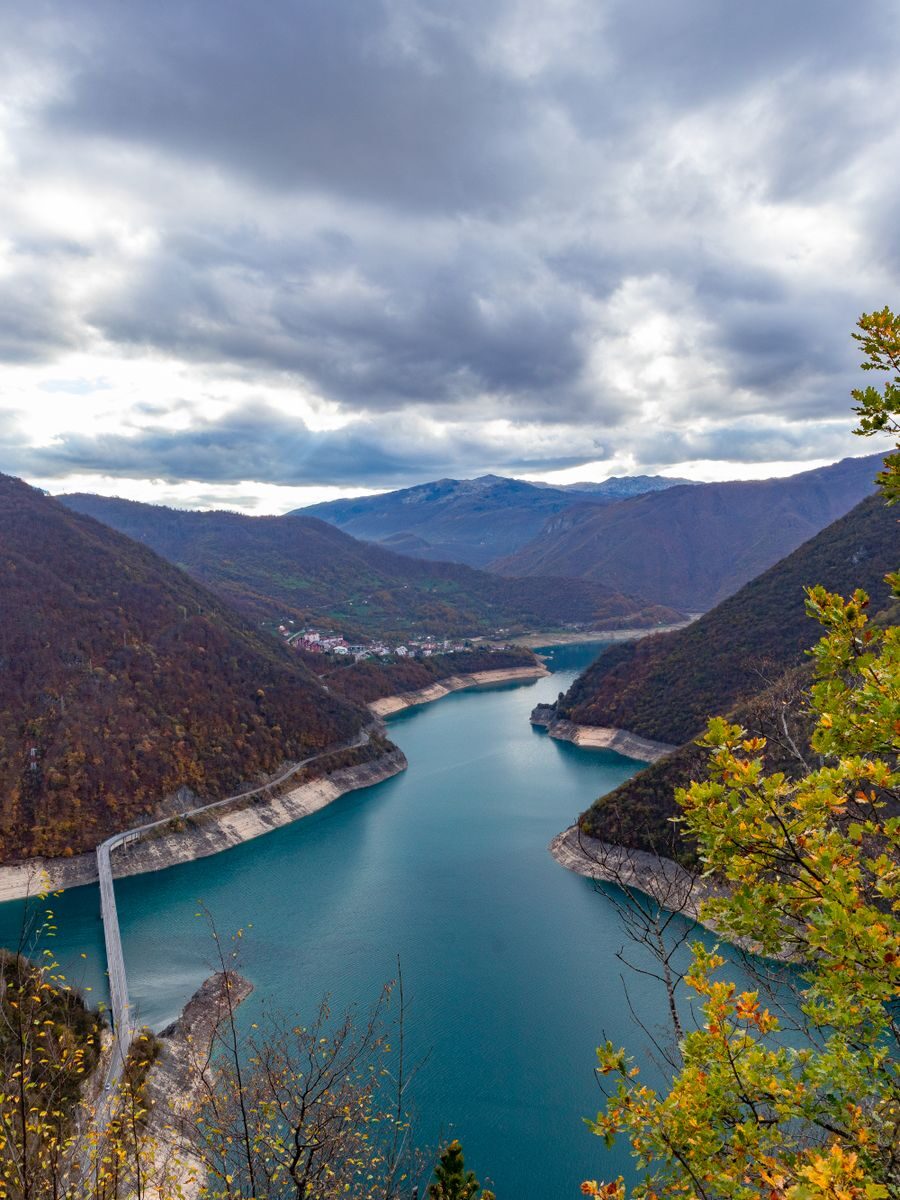 Aerial view of Lake Piva surrounded by mountains in Montenegro, showcasing natural beauty.