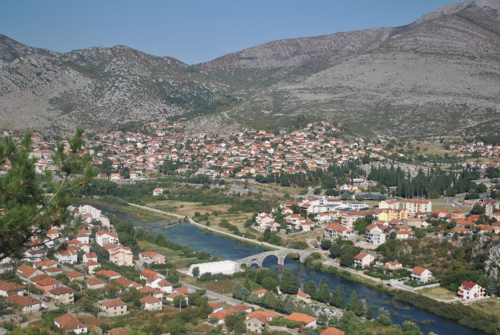Picturesque aerial view of Trebinje, showcasing the old town, bridge, and surrounding mountains.