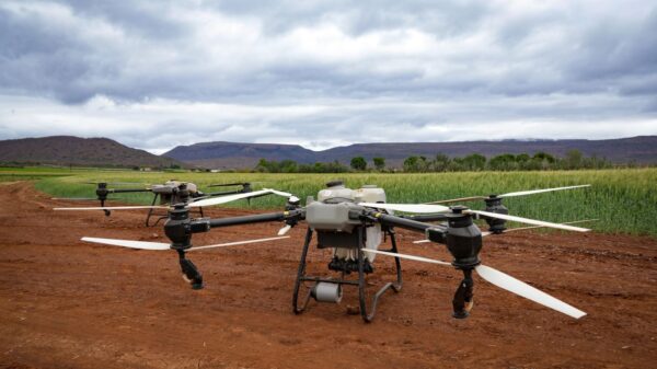 Aerial drones in a field, showcasing modern agricultural technology and landscape.