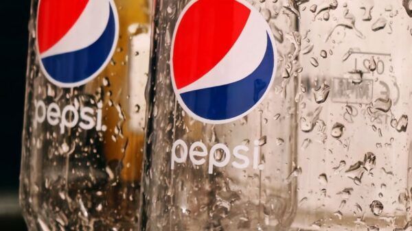 Refreshing close-up of two empty Pepsi glasses covered in water droplets, shot indoors.