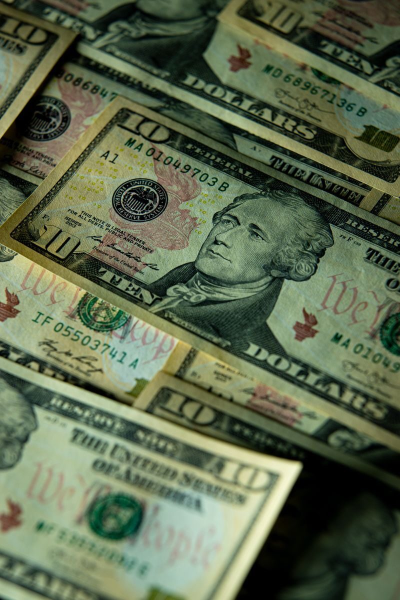 Detailed close-up of multiple US dollar bills highlighting financial themes.