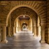 Elegant stone archway corridor at Stanford University, a perfect blend of history and architecture.