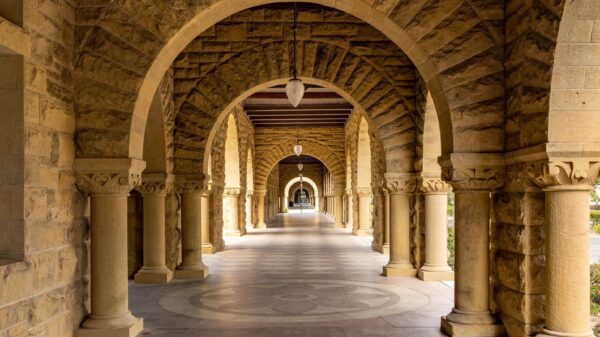 Elegant stone archway corridor at Stanford University, a perfect blend of history and architecture.