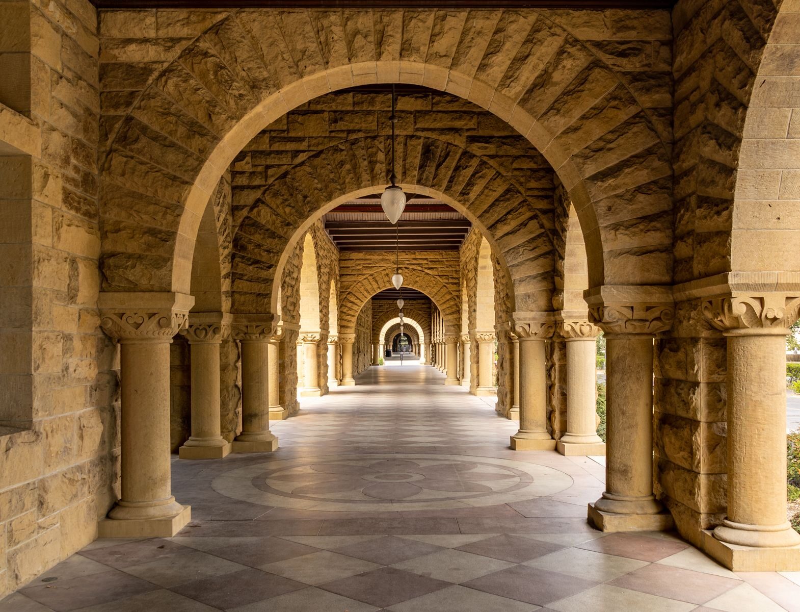 Elegant stone archway corridor at Stanford University, a perfect blend of history and architecture.