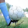 Close-up of a soccer player controlling the ball during a game in Kuttanad.