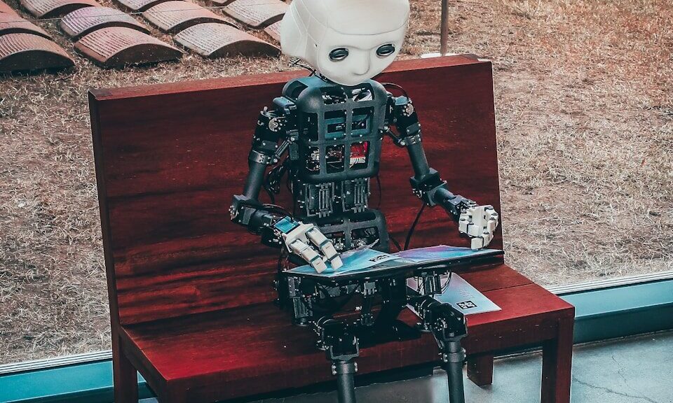 black and white robot toy on red wooden table