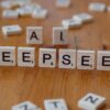 Wooden Scrabble tiles spelling 'DEEPSEEK' with 'AI' on a wooden table, illustrating AI concepts creatively.