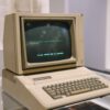 Retro Apple II computer in a museum setting, showcasing vintage technology design.