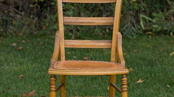 brown wooden chair on grass covered plain