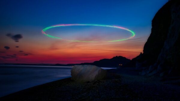 Stunning long-exposure view of sunset with light streaks over Beer Beach, England.