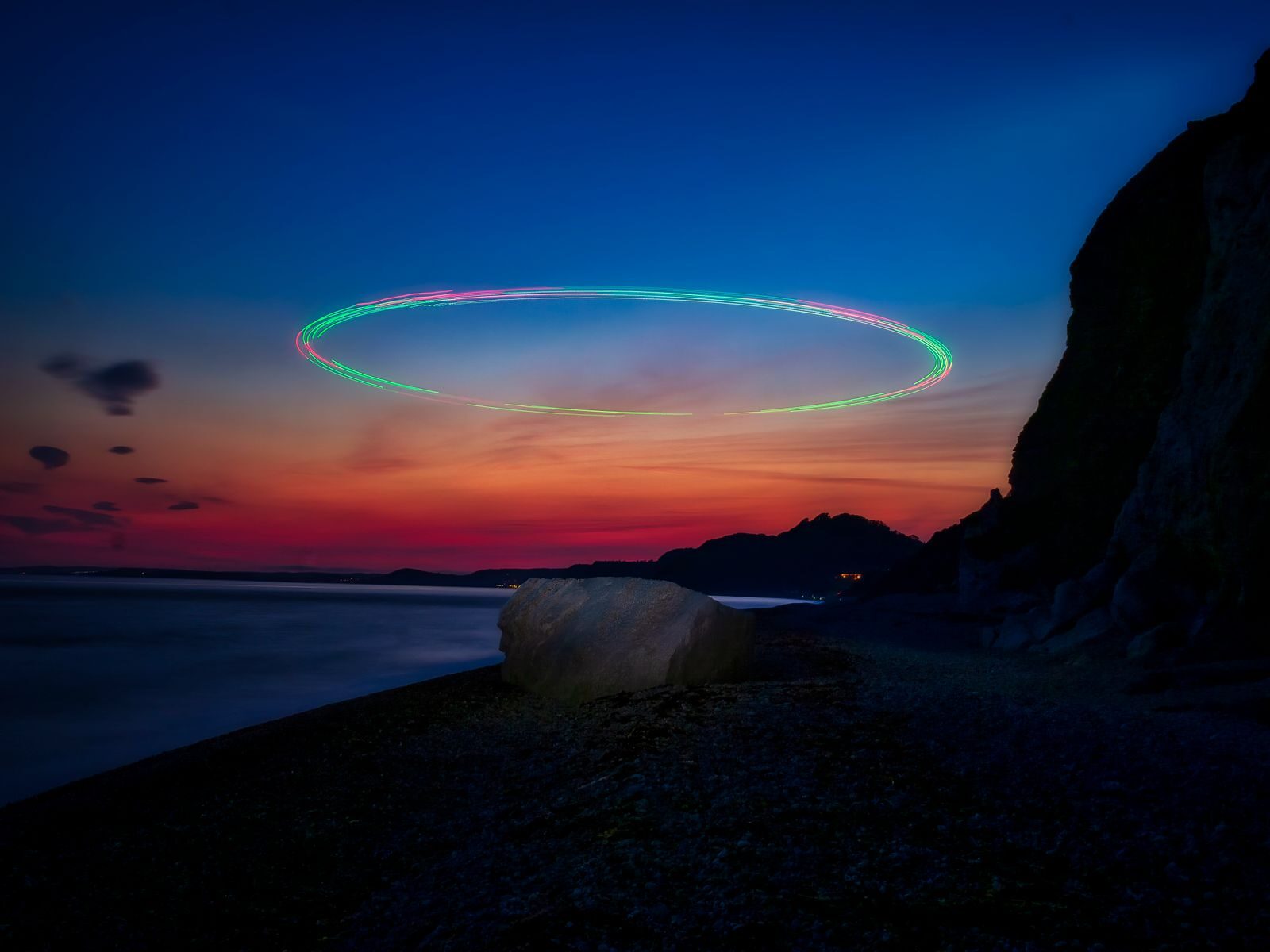 Stunning long-exposure view of sunset with light streaks over Beer Beach, England.