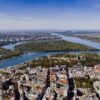 Aerial view showcasing the cityscape of Belgrade, Serbia with the Danube River winding through the landscape.