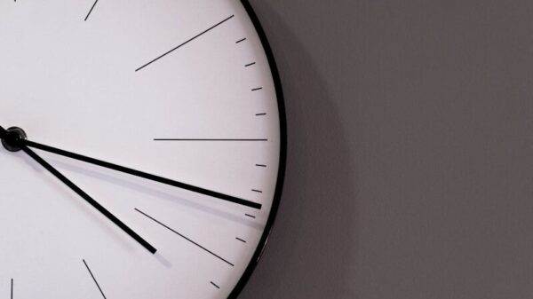 white analog wall clock at 11 00
