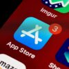 Close-up of App Store icon on iPhone screen with notification badge, highlighting app updates.
