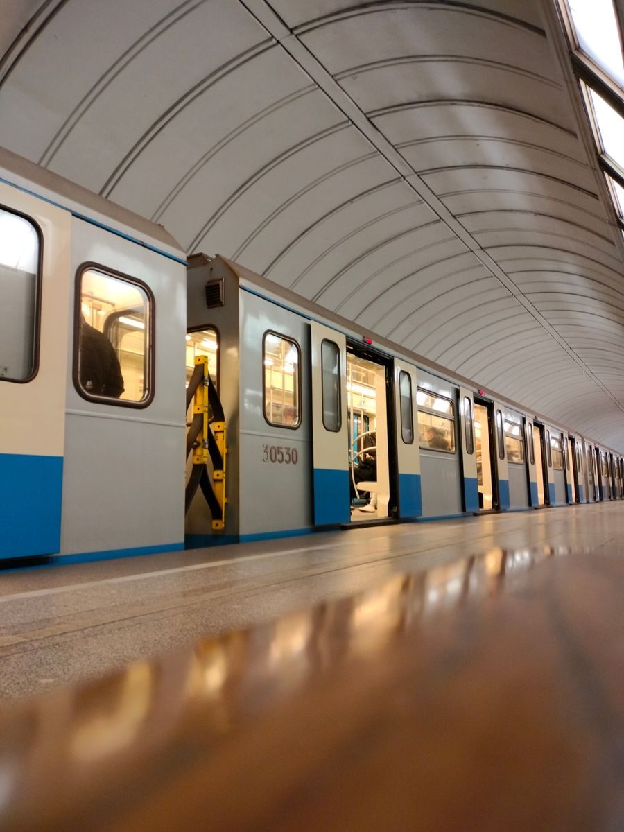 A sleek subway train at a modern urban metro station showcasing public transportation.