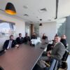 Business professionals in a formal meeting at a modern conference room.