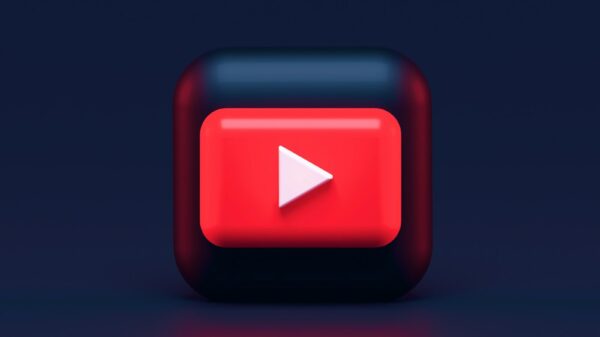 A 3D red play button icon on a dark blue background