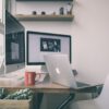 Sleek home office setup with dual monitors, a laptop, and minimalist decor.