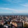 Aerial cityscape of Beograd, Serbia featuring urban skyline and smokestack.