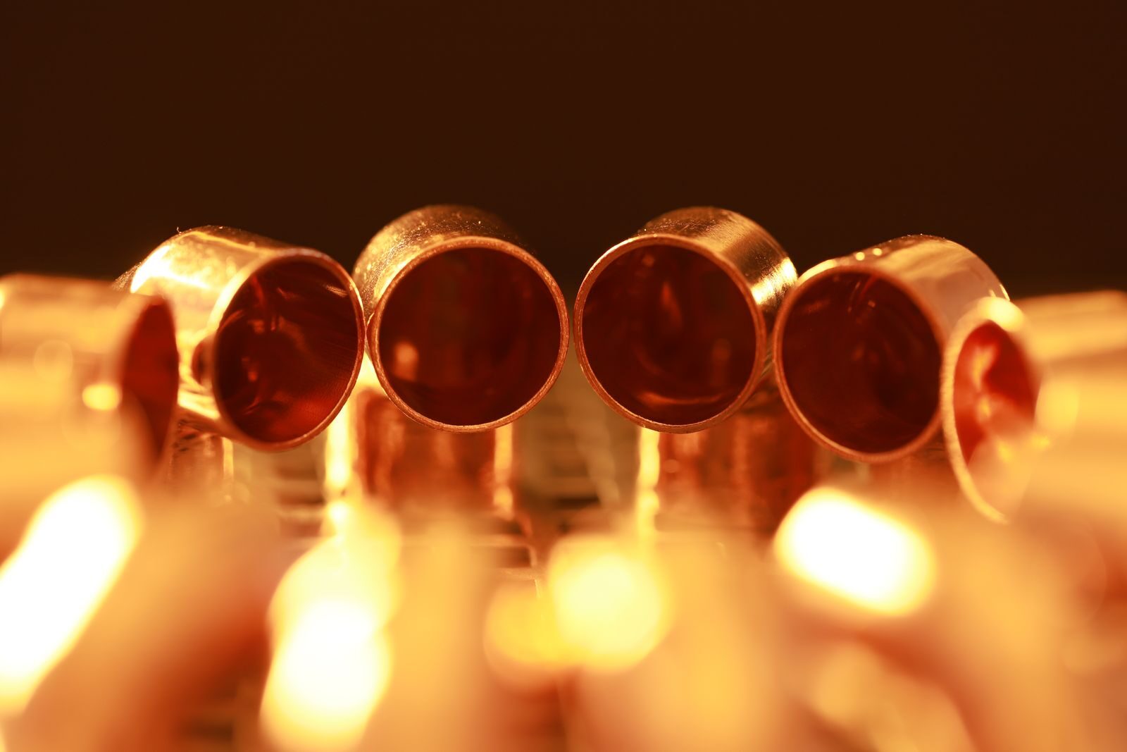 Macro shot of brass tubes with warm, glowing lighting, showcasing a serene and vintage ambiance.