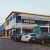 IKEA store exterior with cars parked, showcasing modern architecture.