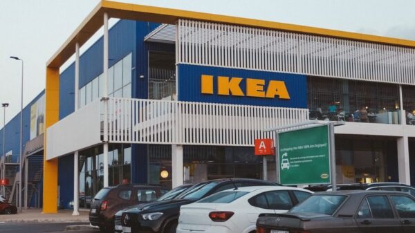 IKEA store exterior with cars parked, showcasing modern architecture.