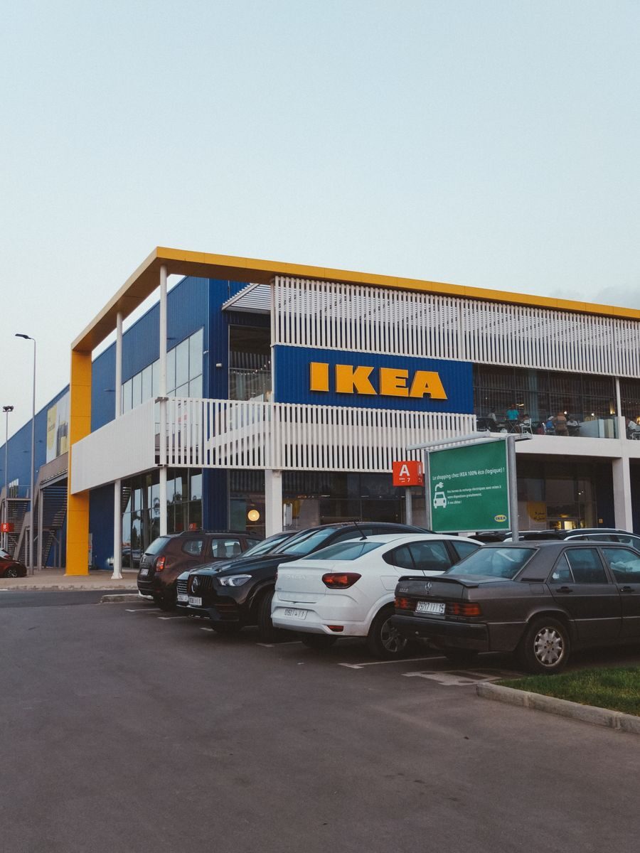 IKEA store exterior with cars parked, showcasing modern architecture.