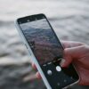 A smartphone capturing ocean waves, highlighting modern mobile photography.