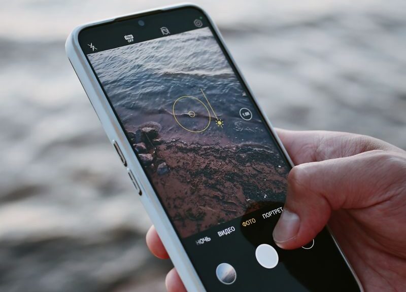 A smartphone capturing ocean waves, highlighting modern mobile photography.