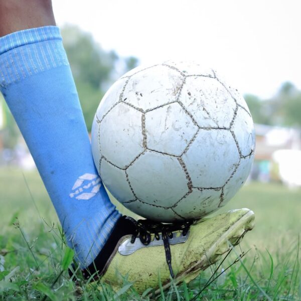 Close-up of a soccer player controlling the ball during a game in Kuttanad.