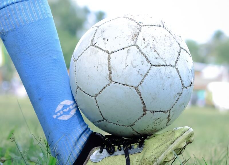 Close-up of a soccer player controlling the ball during a game in Kuttanad.