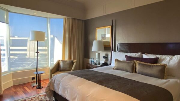 Elegant and spacious boutique hotel room in Mumbai with natural light and chic decor.