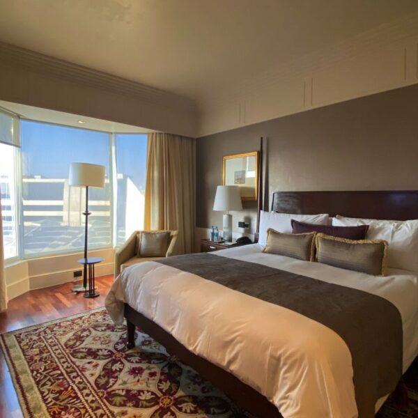 Elegant and spacious boutique hotel room in Mumbai with natural light and chic decor.