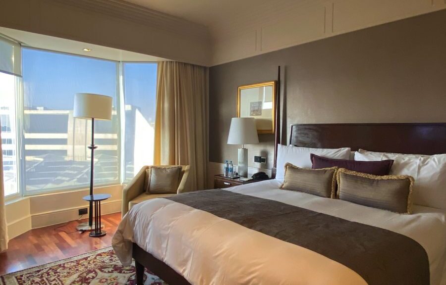 Elegant and spacious boutique hotel room in Mumbai with natural light and chic decor.