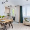 Bright kitchen with dining area in Scandinavian style, featuring minimalist design.
