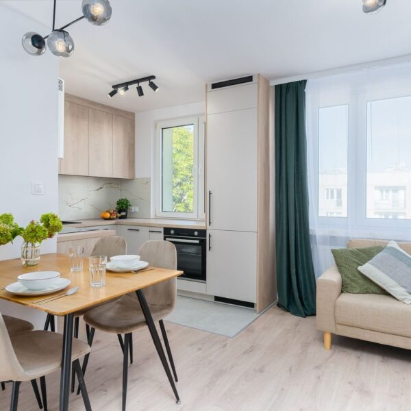 Bright kitchen with dining area in Scandinavian style, featuring minimalist design.