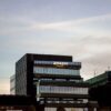 Contemporary architecture showcasing Amazon office at dusk in Iași, Romania.
