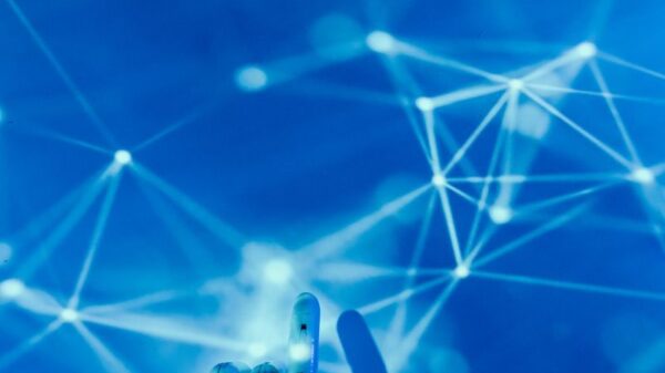 Futuristic robotic hand touching a digital network on a blue background.