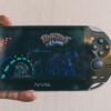 Close-up of a hand holding a PlayStation Vita with Ratchet & Clank displayed on screen. Captured in Johannesburg.
