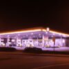 Gas station illuminated at night with glowing lights