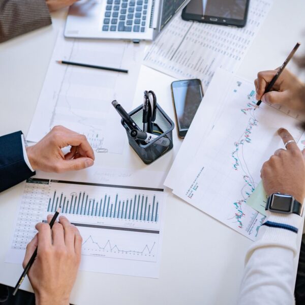 Business team analyzing financial charts and graphs during a collaborative meeting.