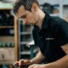 Male worker using a tablet in a warehouse, reflecting productivity and technology integration.