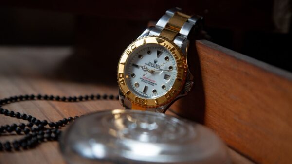 Close-up of a luxury Rolex wristwatch with gold and silver detailing, symbolizing elegance and precision.