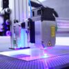 Detailed view of an industrial laser engraving machine in action, highlighting precision equipment.